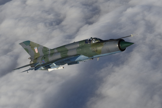 Military jet flying through clouds free wallpaper - medium preview image