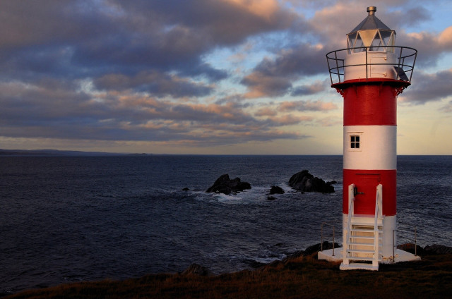 Red white lighthouse rocky shore free wallpaper - medium preview image