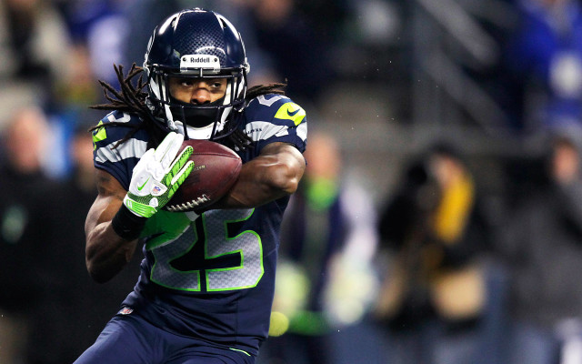 Football player holding ball crowd free wallpaper - medium preview image