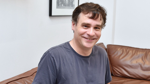 Man smiling couch brown leather free wallpaper - medium preview image