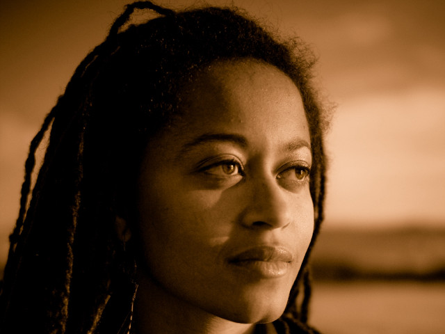 Woman dreadlocks serious look camera free wallpaper - medium preview image