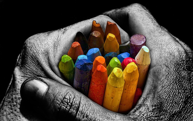 Person holding colored crayons hands free wallpaper - medium preview image