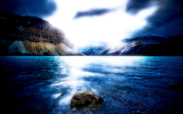 Rock lake mountains cloudy sky free wallpaper - medium preview image
