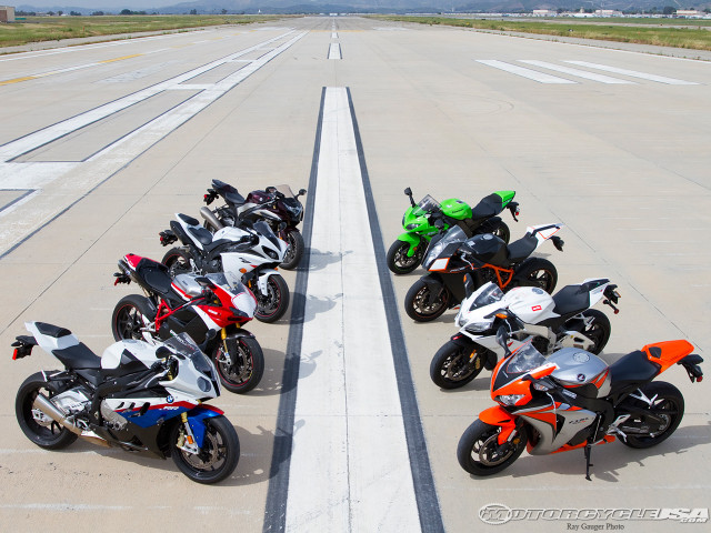Motorcycles parked runway sky background free wallpaper - medium preview image