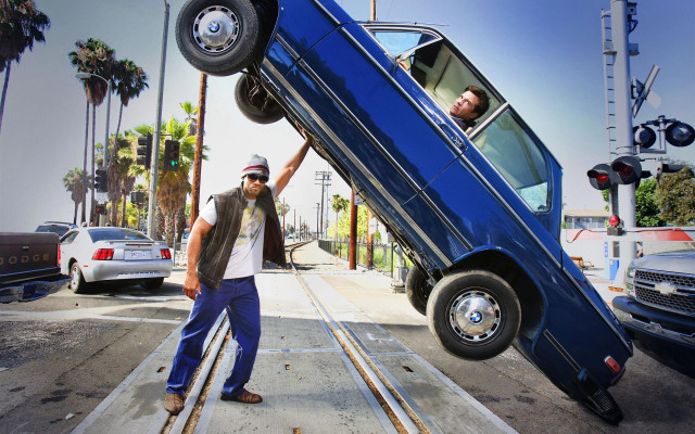 Man standing car upside down free wallpaper - medium preview image