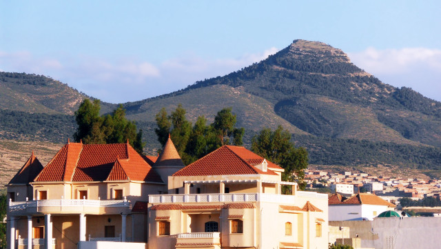 Large building mountain sky clouds free wallpaper - medium preview image