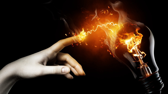 Hand holding lightbulb flame pointing free wallpaper - medium preview image
