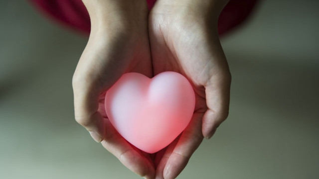 Person holding heart pink glow free wallpaper - medium preview image