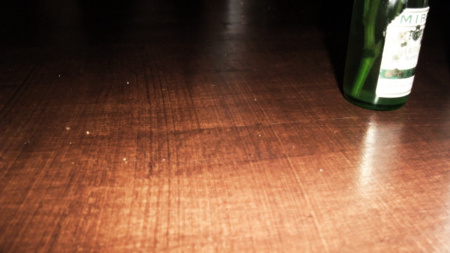 Wine bottle wooden table blurry free wallpaper - medium preview image