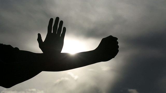 Outstretched hand sun clouds dark free wallpaper - medium preview image