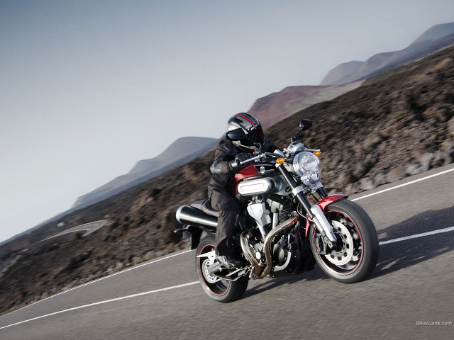 Man motorcycle road mountain range free wallpaper - medium preview image