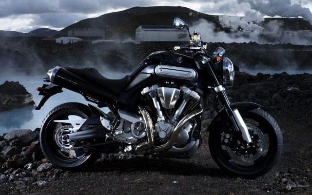 Motorcycle parked rocky road water free wallpaper - medium preview image