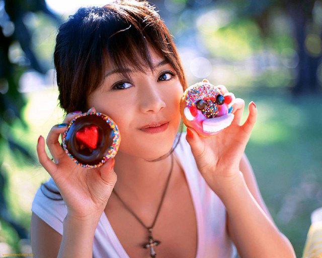 Woman holding two donuts with free wallpaper - medium preview image