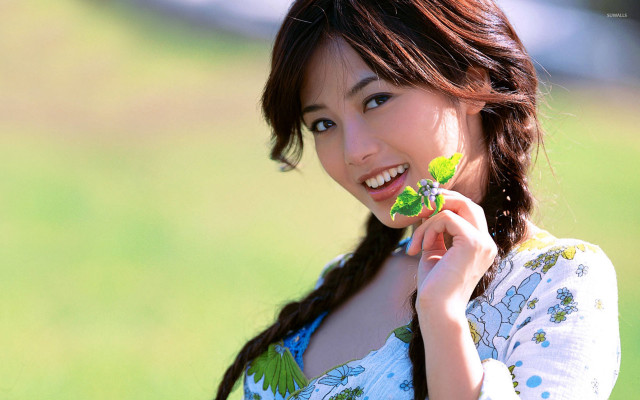 Woman holding leaf smiling green #2 free wallpaper - medium preview image
