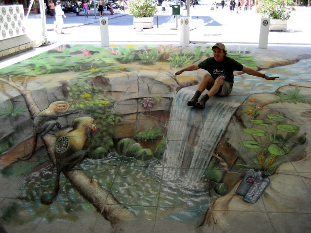 Man sitting rock waterfall painted free wallpaper - medium preview image