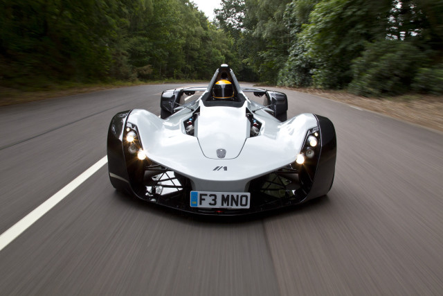 White racecar driving forest road free wallpaper - medium preview image