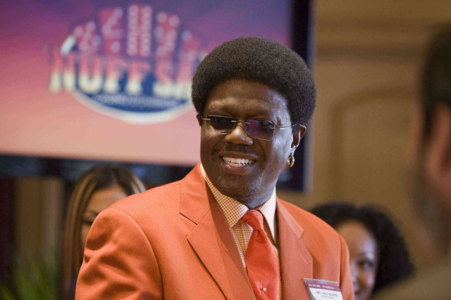 Man orange suit smiling room free wallpaper - medium preview image