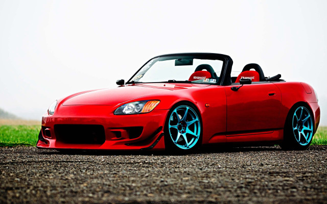 Red sports car gravel road free wallpaper - medium preview image