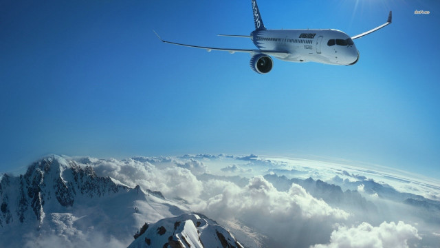 Plane flying mountain range clouds free wallpaper - medium preview image
