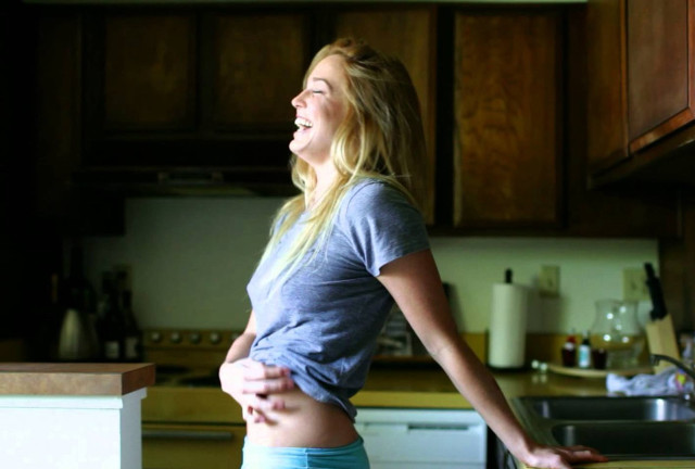 Woman kitchen stomach exposed hands free wallpaper - medium preview image