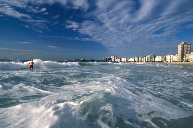 Person ocean city waves sunny free wallpaper - medium preview image