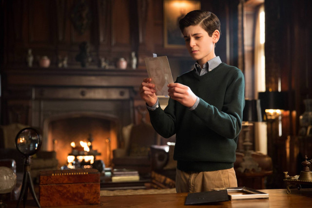 Boy green sweater holding paper free wallpaper - medium preview image