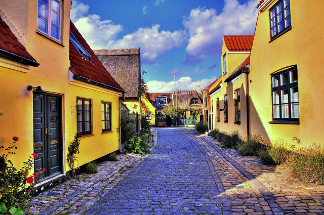 Cobblestone street yellow buildings red free wallpaper - medium preview image