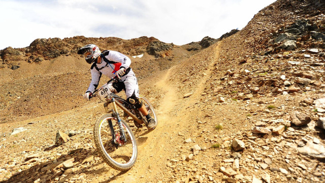 Man riding bike dirt road #2 free wallpaper - medium preview image