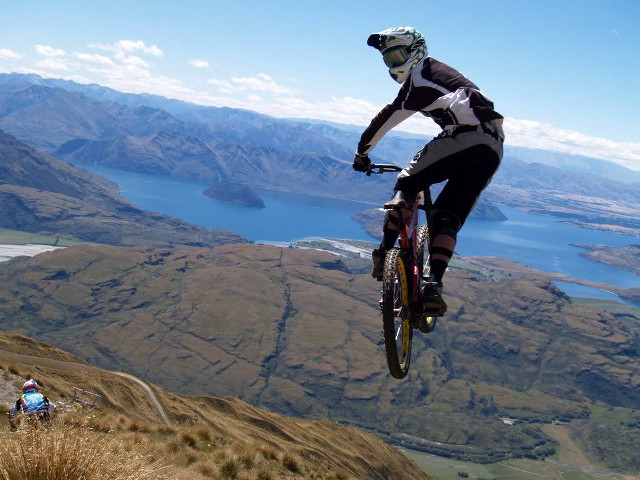Man riding bike mountain lake free wallpaper - medium preview image