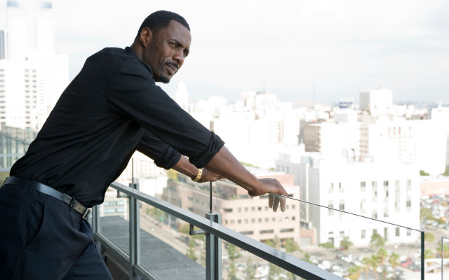 Man leaning railing balcony cityscape free wallpaper - medium preview image