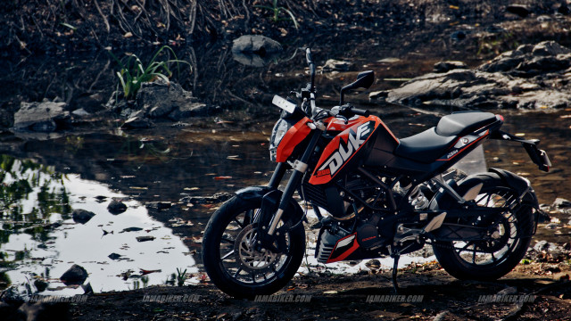 Motorcycle parked dirt road water free wallpaper - medium preview image