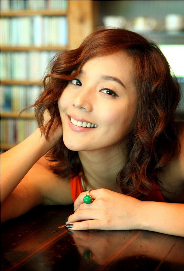 Red haired woman smiling table free wallpaper - medium preview image