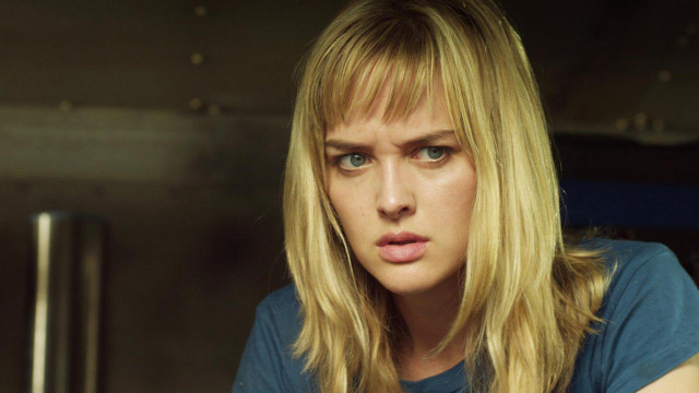 Blonde woman blue shirt serious #2 free wallpaper - medium preview image