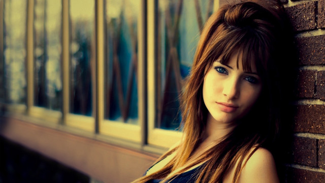 Woman brick wall serious look free wallpaper - medium preview image