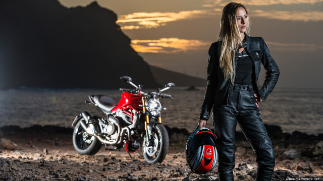 Woman motorcycles rocky beach sunset free wallpaper - medium preview image