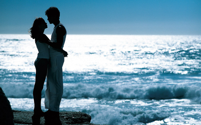 Couple standing rock ocean blue free wallpaper - medium preview image