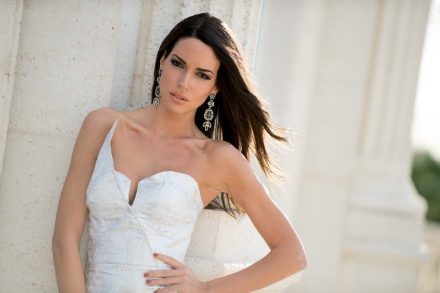 Woman white dress leaning wall #5 free wallpaper - medium preview image
