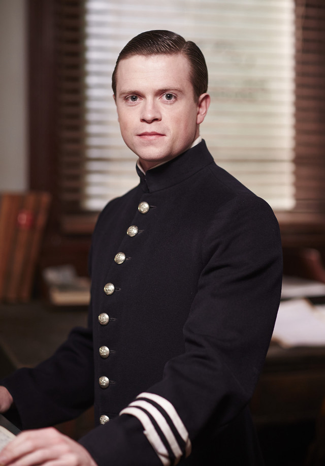 Man uniform sitting desk keyboard free wallpaper - medium preview image