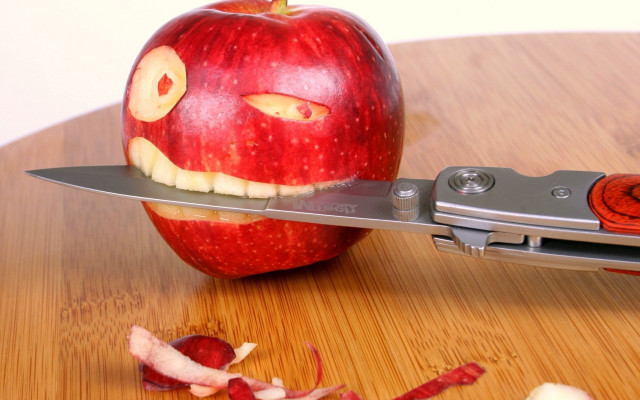 Knife cutting apple face background free wallpaper - medium preview image