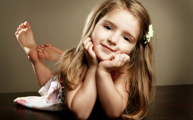 Little girl smiling table hands free wallpaper - medium preview image