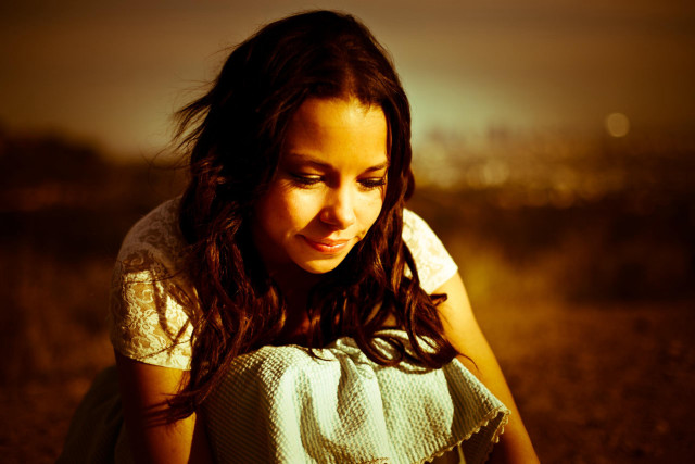 Girl sitting field cellphone city free wallpaper - medium preview image