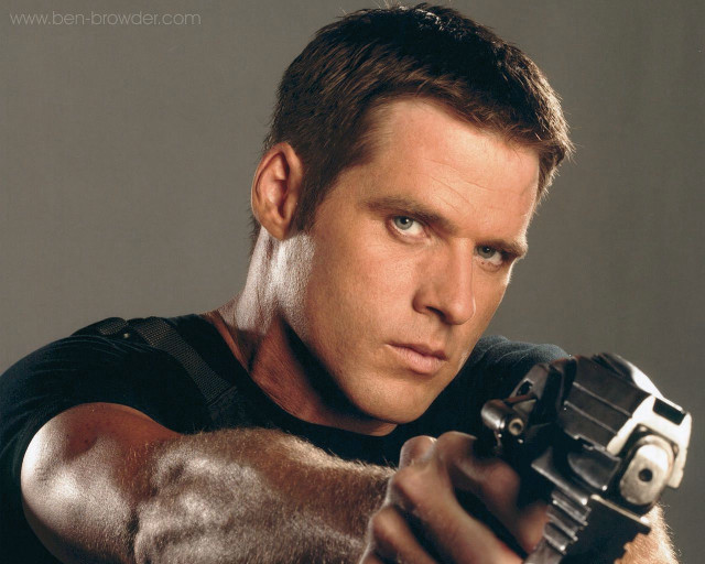 Man holding gun serious expression free wallpaper - medium preview image