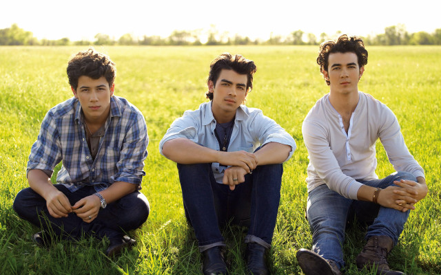 Three young men sitting field free wallpaper - medium preview image