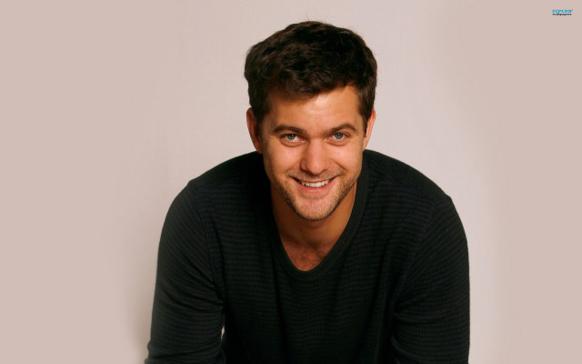 Man smiling black shirt sitting free wallpaper - medium preview image