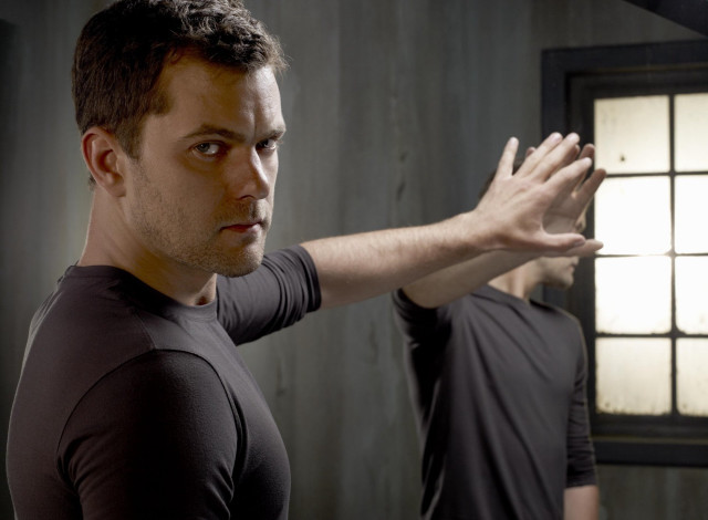 Man standing window hands outside free wallpaper - medium preview image