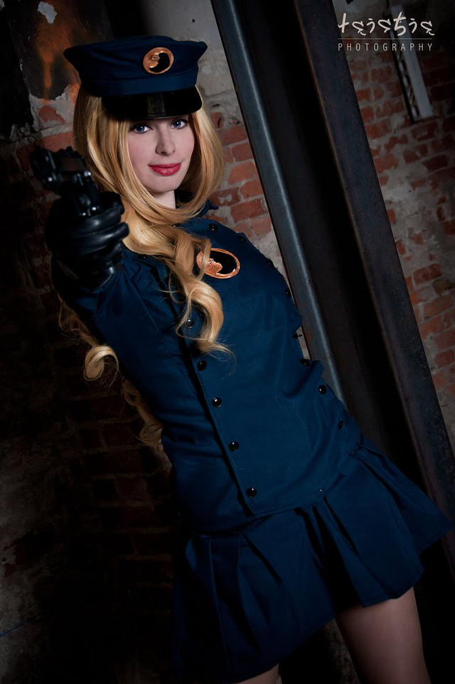 Woman uniform gun pose brick free wallpaper - medium preview image