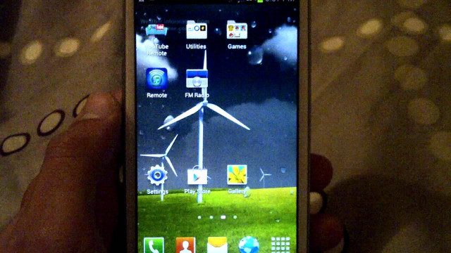 Person holding smartphone windmill screen free wallpaper - medium preview image