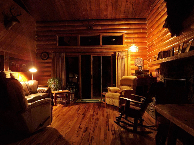 Livingroom woodenceiling fireplace rockingchair warmlighting free wallpaper - medium preview image