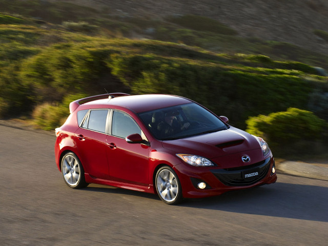 Red car driving road green free wallpaper - medium preview image