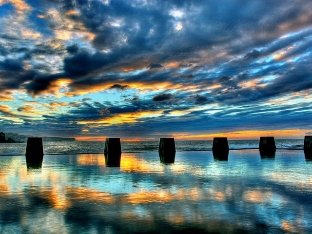 Poles beach cloudy sunset sky free wallpaper - medium preview image